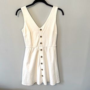 White dress with buttons. Mid length.Fitted on top. Very soft material!
